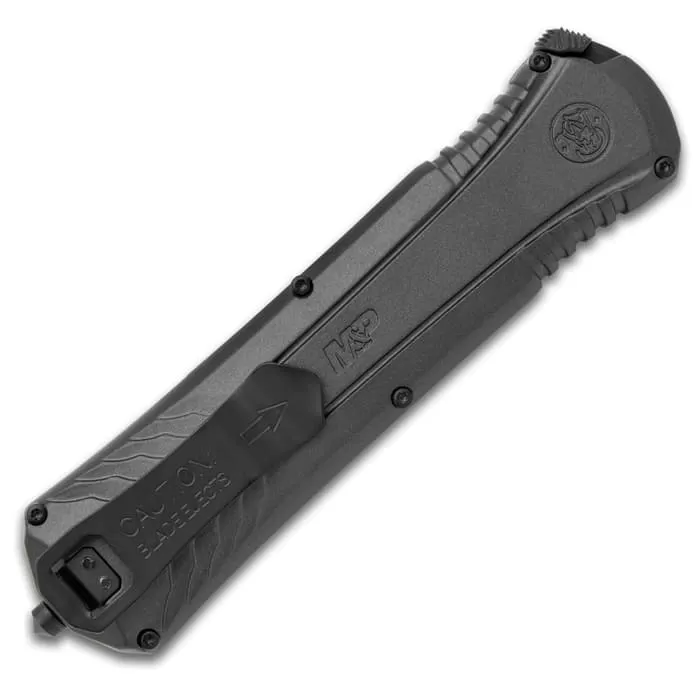 Smith & Wesson Serrated OTF Pocket Knife - AUS-8 Stainless Steel Blade, Aluminum Handle, Glassbreaker - Length 8 3/5” 5 Smith & Wesson Serrated OTF Pocket Knife - AUS-8 Stainless Steel Blade, Aluminum Handle, Glassbreaker - Length 8 3/5” - Image 3